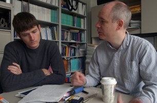 Male-College-Student-Meeting-With-Professor-At-Office-Hours-To-Discuss-Reading-Homework-Assignment-400x265